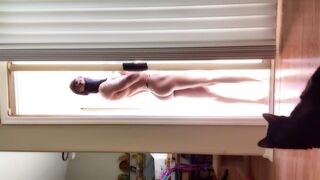 Butt: fit gym gal teasing throughout glass door in backyard