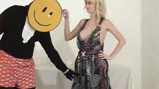 dude wearing large smiley face strips woman and puts a pie down her pants